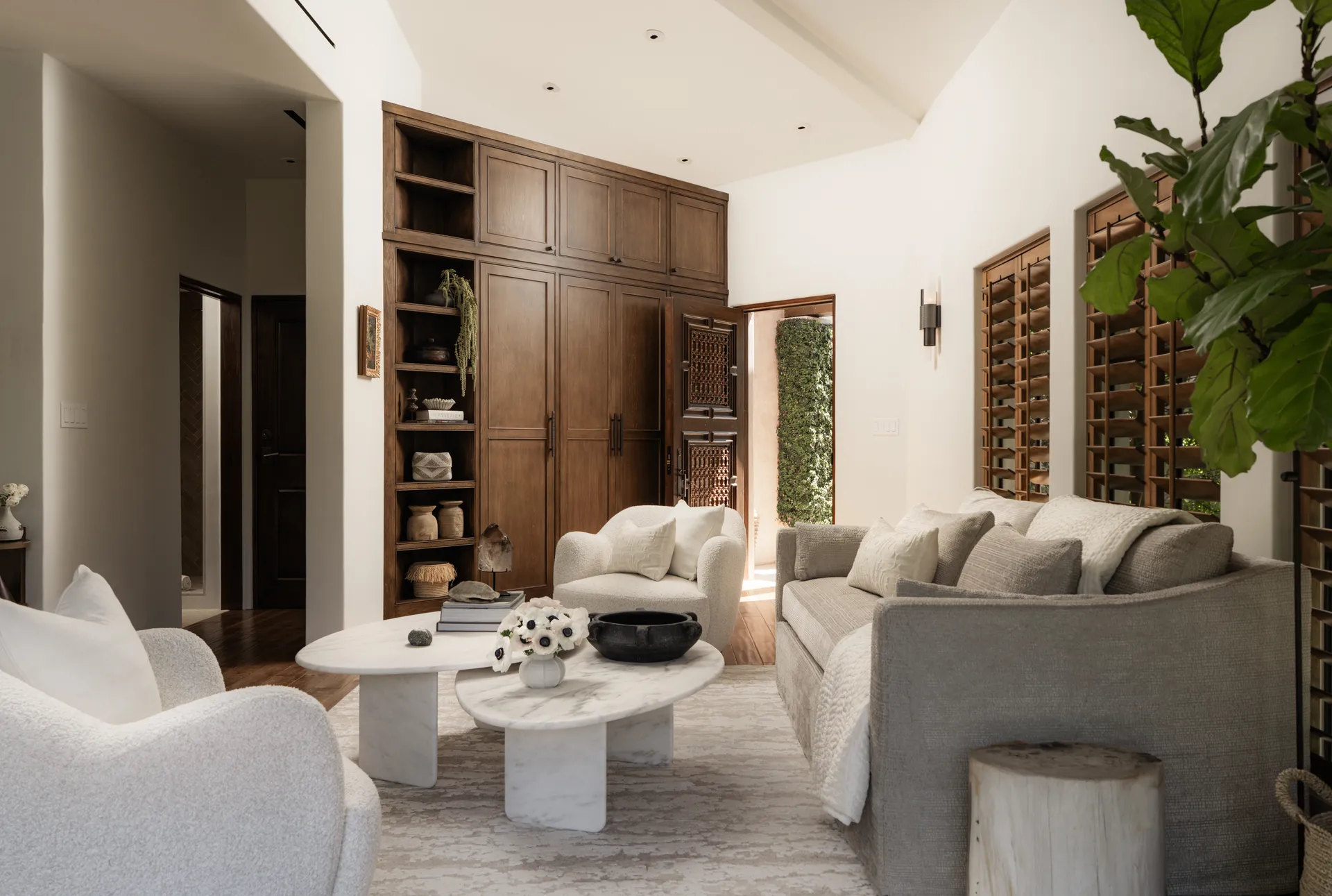 Modern living room featuring neutral sectional sofa, white marble coffee table, walnut built-in cabinetry and wine storage, House Rupert interior design Santa Barbara and Montecito